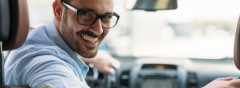 Portrait of a handsome businessman driving car